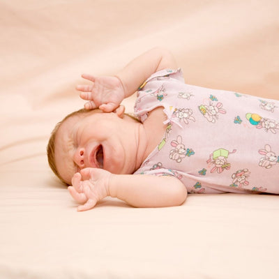 Why do newborns move and fidget during their sleep?
