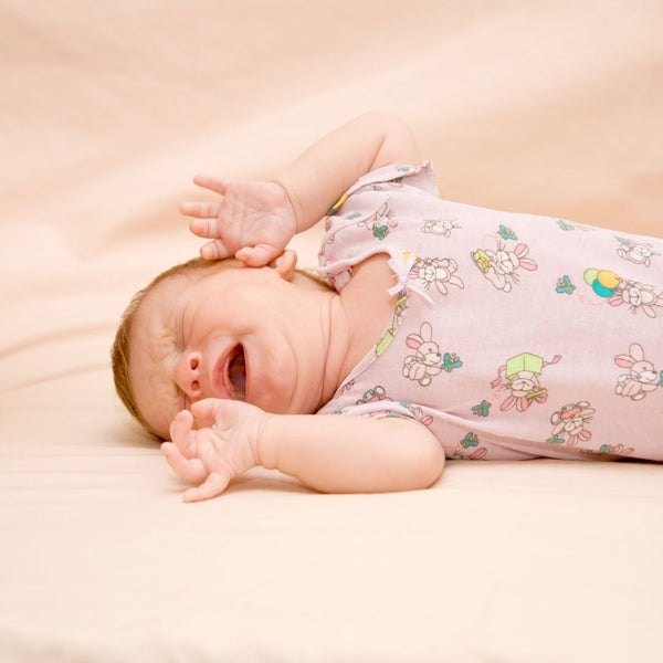 Why do newborns move and fidget during their sleep?